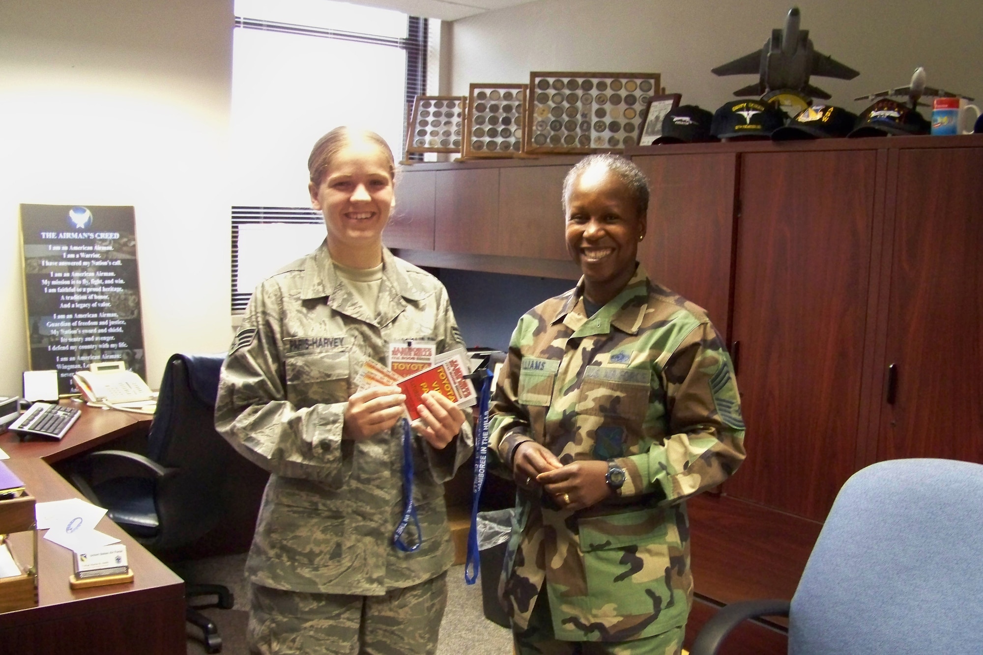 Senior Airman Samantha Paris-Harvey, an information manager with the 88th Air Base Wing at Wright-Patterson Air Force Base, Ohio is presented free tickets to the Jamboree in the Hills festival by Chief Master Sgt. Heather Williams, 88th Mission Support Group superintendent. The America Supports You organization provided 100 VIP concert tickets to Wright-Patterson Airmen, donated courtesy of Toyota. The tickets were good for all four days of the festival which featured country music artists like Brooks & Dunn, Reba McEntire and Brad Paisley.  (U.S. Air Force photo/Tech. Sgt. Lisa Coker)