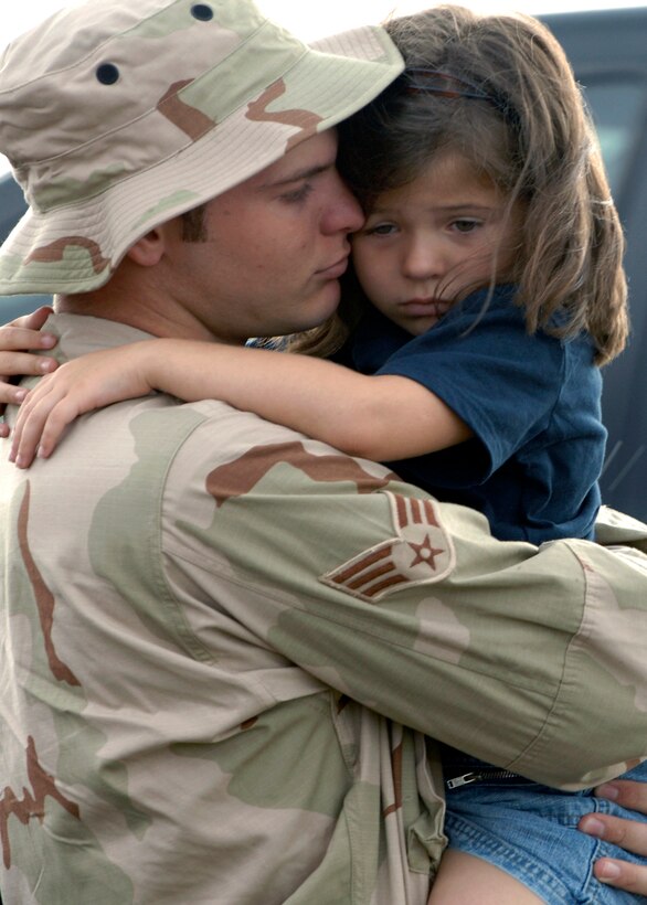 Senior Airman William Seaborne, 28th Aircraft Maintenance Squadron hydraulic mechanic, hugs his five-year-old daughter Riley here July 22. Airman Seaborne will be deployed to Southwest Asia. (U.S. Air Force photo/Airman Matthew Flynn)