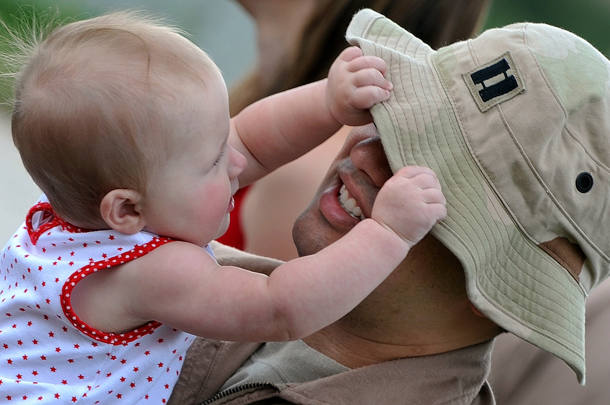 Capt. Steven Fowler, 34th Bomb Squadron weapons system operator, holds his seven-month-old daughter Makenna while waiting outside of the deployment center, July 22,. Captain Fowler is deploying to Southwest Asia in support of Operations Iraqi Freedom and Enduring Freedom. (U.S. Air Force photo/Senior Airman Marc I. Lane)