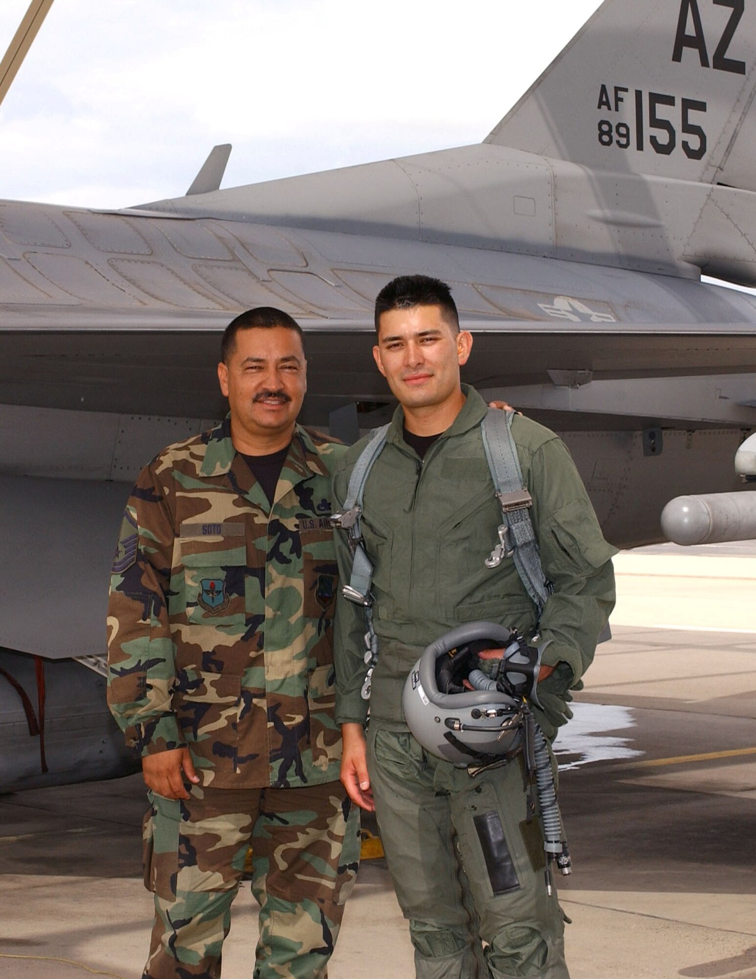 Master Sgt. Alfonso Soto (left), an F-16 crew chief, and his son Senior Airman Guillermo Soto meet up on the flightline after Airman Soto’s incentive flight. Airman Soto, an electronics technician, flew July 13 as reward for earning Airman of the Quarter for the wing. His father was the crew chief who launched the flight. "I'm so proud that my son was selected for Airman of the Quarter and it's a
once-in-a-lifetime opportunity to be able to launch him on an F-16
flight," said Sergeant Soto. (Air National Guard Photo by Senior Airman Sara Elliott.)