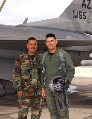 Master Sgt. Alfonso Soto (left), an F-16 crew chief, and his son Senior Airman Guillermo Soto meet up on the flightline after Airman Soto’s incentive flight. Airman Soto, an electronics technician, flew July 13 as reward for earning Airman of the Quarter for the wing. His father was the crew chief who launched the flight. "I'm so proud that my son was selected for Airman of the Quarter and it's a
once-in-a-lifetime opportunity to be able to launch him on an F-16
flight," said Sergeant Soto. (Air National Guard Photo by Senior Airman Sara Elliott.)