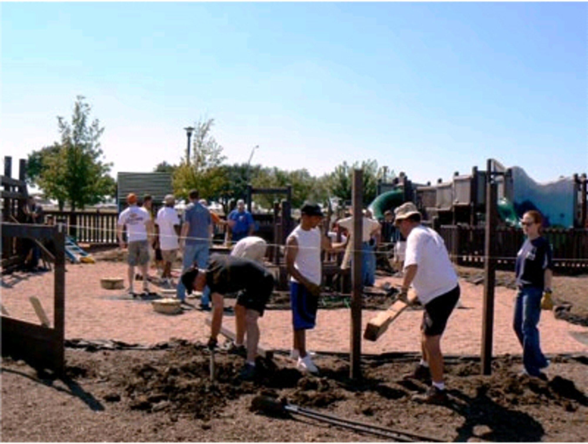 ABILENE, Texas -- Members of the Dyess We Care Team help rebuild the Junior League of Abilene Fort Imagination playground. The playground was vandalized in October 2007. The WCT volunteered to help rebuild Western-theme park. The Dyess We Care Team (WCT) is a volunteer organization made up of active duty Air Force, civilians, retired military members, and their families who volunteer to help the disabled, elderly, and others in need of minor home repairs. In addition, the WCT assists other non-profit agencies. (Courtesy photo)