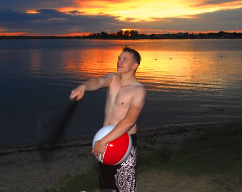RICE LAKE, N.D. – Staff Sgt. Benjamin Washburn, 5th Communications Squadron computer support technician plays with a beach ball at Rice Lake on the evening of July 20 at Rice Lake. Sergeant Washburn, along with other Airmen from Minot AFB, visited the lake to relax and enjoy a cool swim in the clear waters. (U.S. Air Force photo by Airman 1st Class Benjamin Stratton)