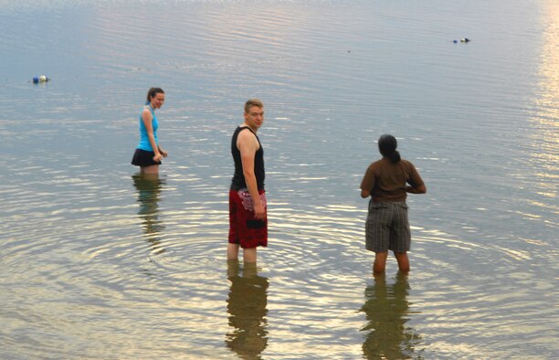 RICE LAKE, N.D. – Airman 1st Class Lisa Washburn, 5th Force Support Squadron food handler, Staff Sgt. Benjamin Washburn, 5th Communications Squadron computer support technician and Airman 1st Class Qushondra Owens, 5th FSS food service apprentice enjoy a swim in Rice Lake on the evening of July 20. The group visited the lake to relax and enjoy a cool swim in the clear waters. (U.S. Air Force photo by Airman 1st Class Benjamin Stratton)