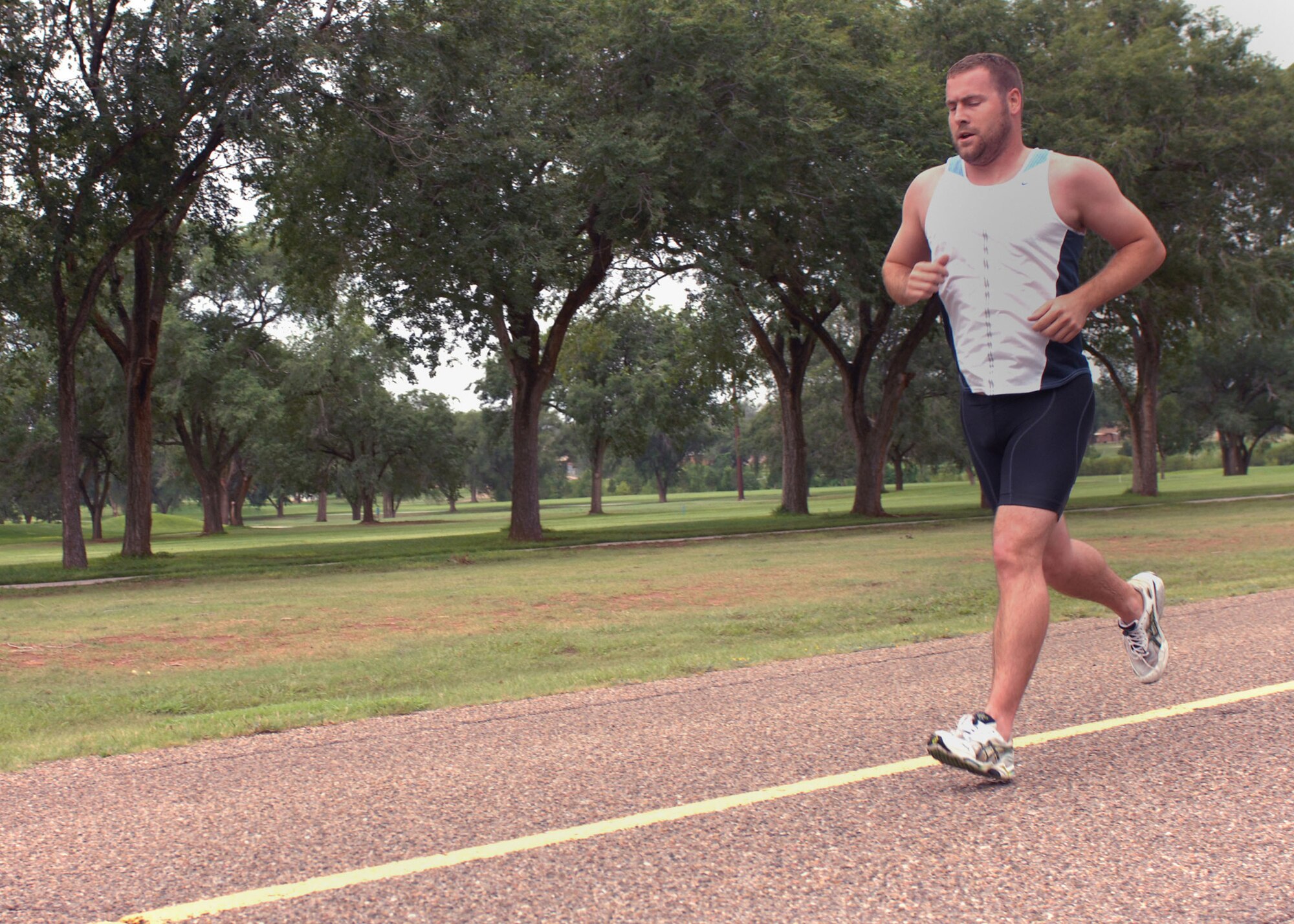 CANNON AIR FORCE BASE, N.M.-- Scott Percival runs the 5K portion of the Splash and Dash on July 19. Mr. Percival completed the run with a time of 30:45. Competitors also swam 500 meters during the event. (U.S. Air Force photo by Airman 1st Class James R. Bell)