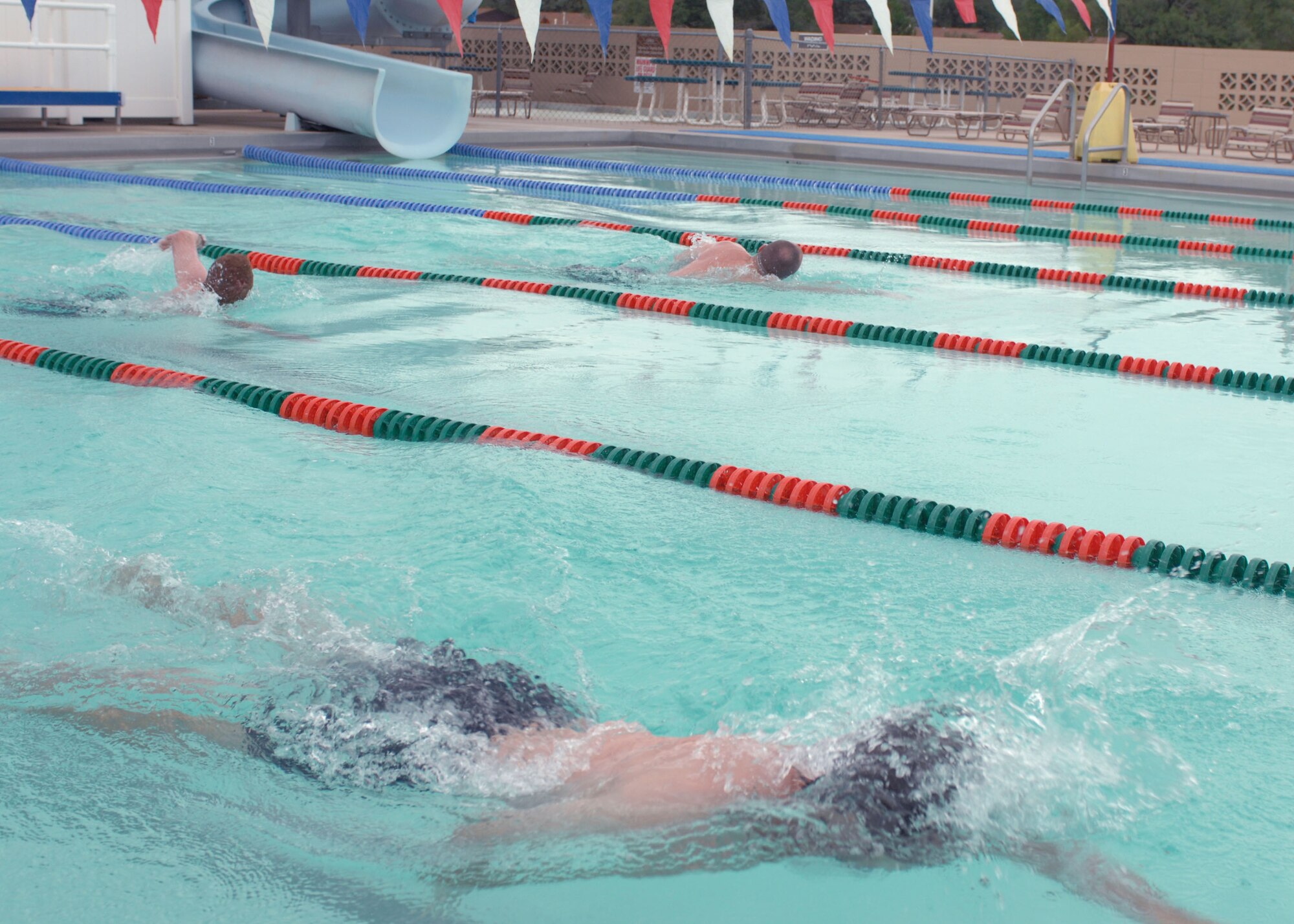 CANNON AIR FORCE BASE N.M.--  Scott Percival leads Tech. Sgt. Keith Eberhardt, 27th Special Operations Medical Dental Squadron, and Staff Sgt. Jeremy Bushnell, 27th Special Operations Communication Squadron, during the 500-meter swim portion of the Splash and Dash on July 19. The event included a 5K run and was hosted by the 27th Special Operations Services Squadron. (U.S. Air Force photo by Airman 1st Class James R. Bell)
