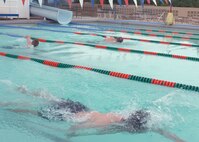 CANNON AIR FORCE BASE N.M.--  Scott Percival leads Tech. Sgt. Keith Eberhardt, 27th Special Operations Medical Dental Squadron, and Staff Sgt. Jeremy Bushnell, 27th Special Operations Communication Squadron, during the 500-meter swim portion of the Splash and Dash on July 19. The event included a 5K run and was hosted by the 27th Special Operations Services Squadron. (U.S. Air Force photo by Airman 1st Class James R. Bell)