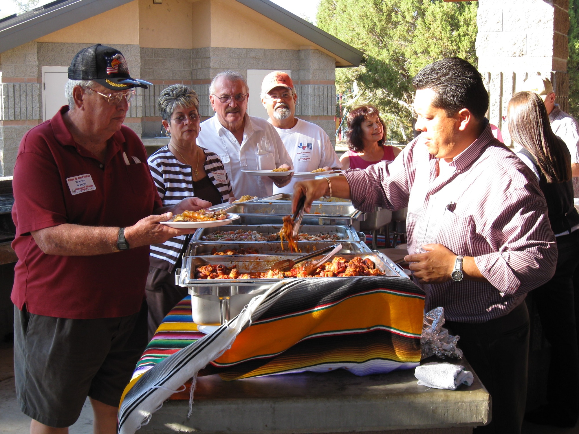 Wayne Wright, Maria and Andy Wolfel, and Frank and Betty Maldonado line up for the feast.