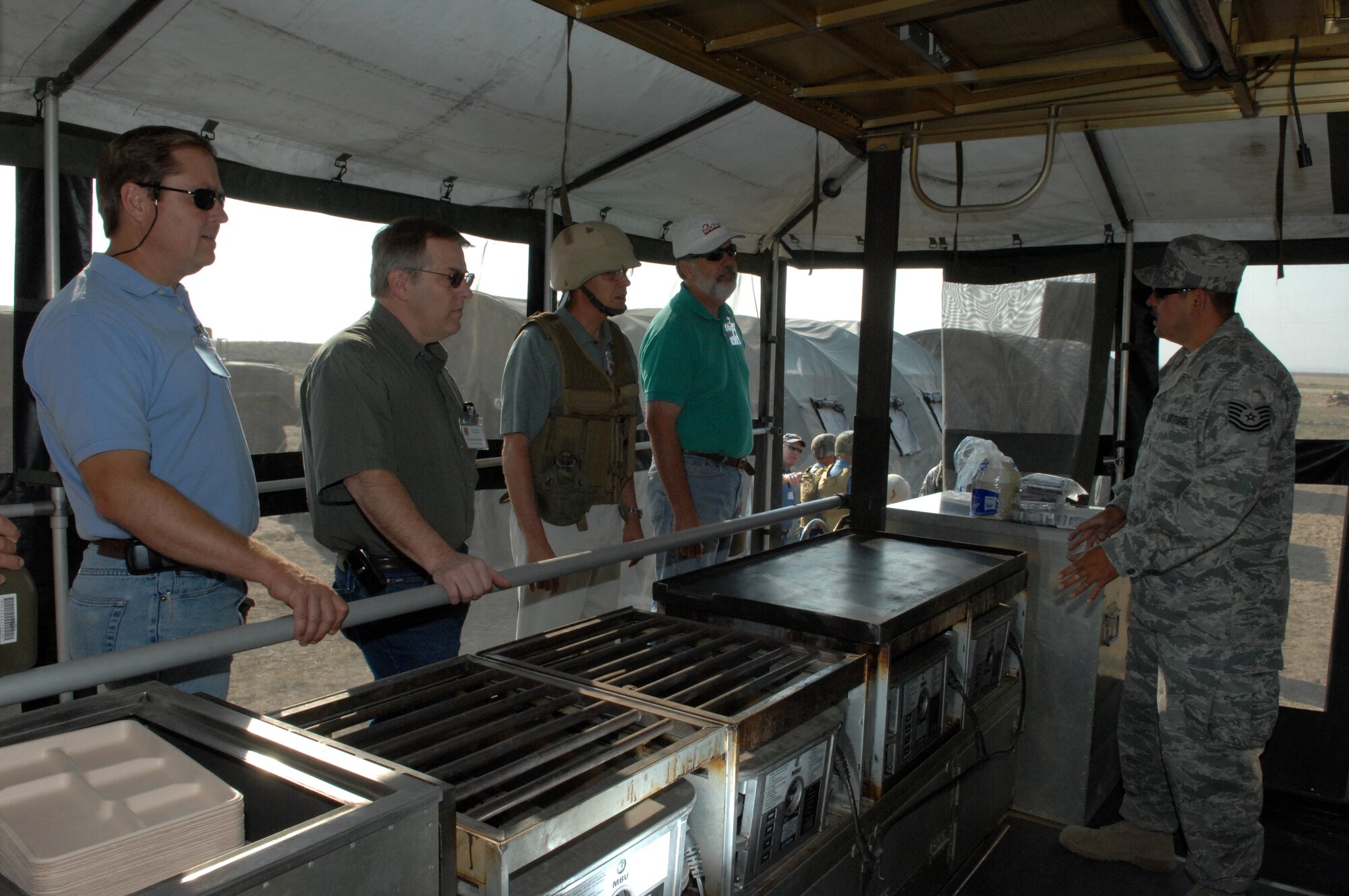 MOUNTAIN HOME AIR FORCE BASE, Idaho – Members of the Honorary Commanders program fire M-16 rifles during the Air Expeditionary Day tour, July 16. Hosted by the 726th Air Control Squadron and the wing's public affairs staff, the half-day visit to the squadron's austere deployment training area offered honorary commanders a greater understanding of the missions Airmen are currently carrying out in Iraq, Afghanistan and numerous other deployed locations. Designed to increase the understanding of the 366th Fighter Wing and Air Force missions, the honorary commanders program annually pairs community, civic and business leaders with Gunfighter unit commanders and leadership. Throughout the year, honorary commanders participated in unique, creative events, hosted by each of the four groups, to learn about each aspect of the wing's missions. (U.S. Air Force photo/Airman 1st Class Ashley Winters)
