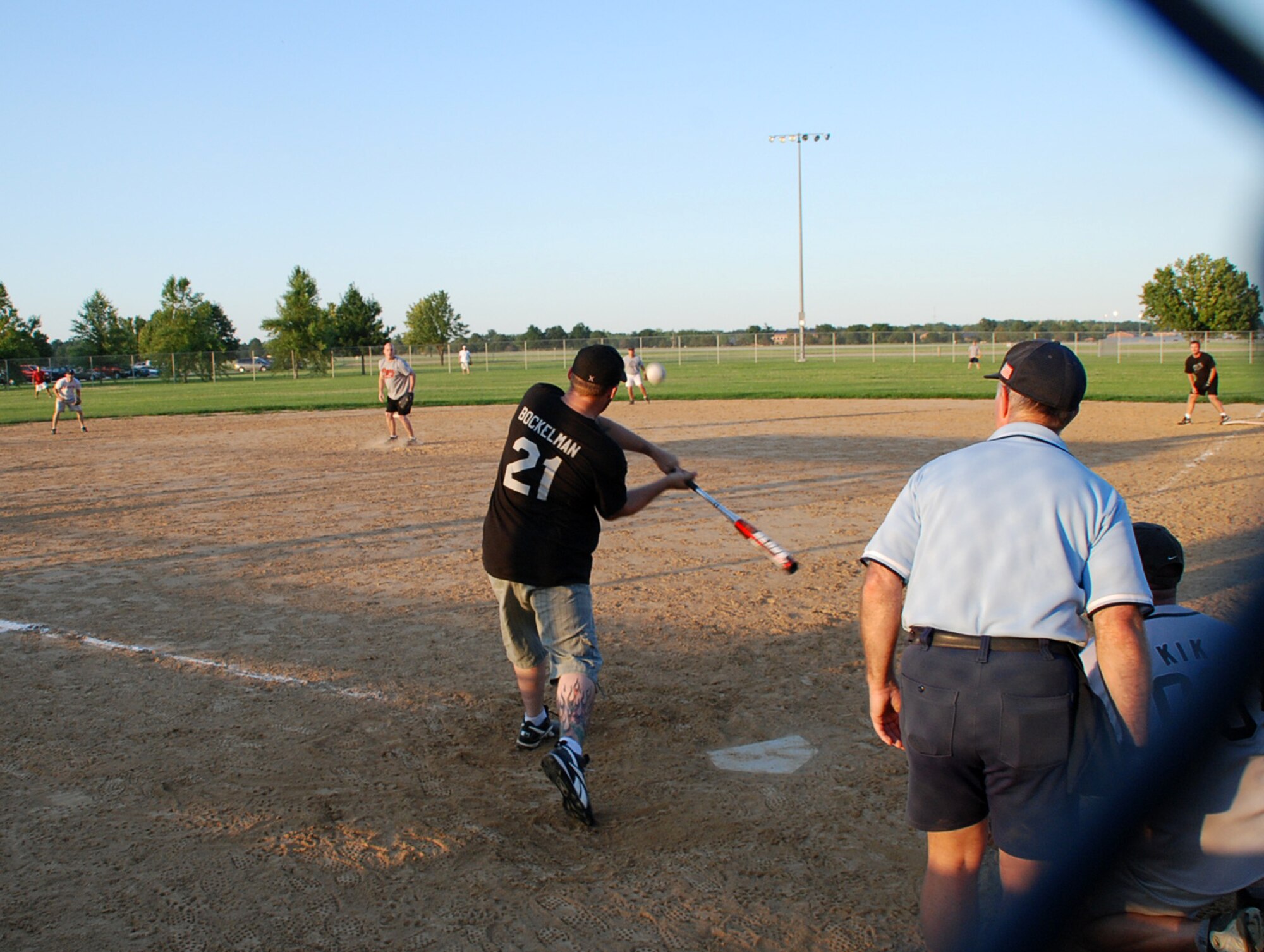 932nd Airlift Wing members gathered for a game of fun and exercise.  Here Staff Sgt. Anthony Bockelman crushes a softball to the outfield while his team cheers him on.  Photo/Maj. Stan Paregien