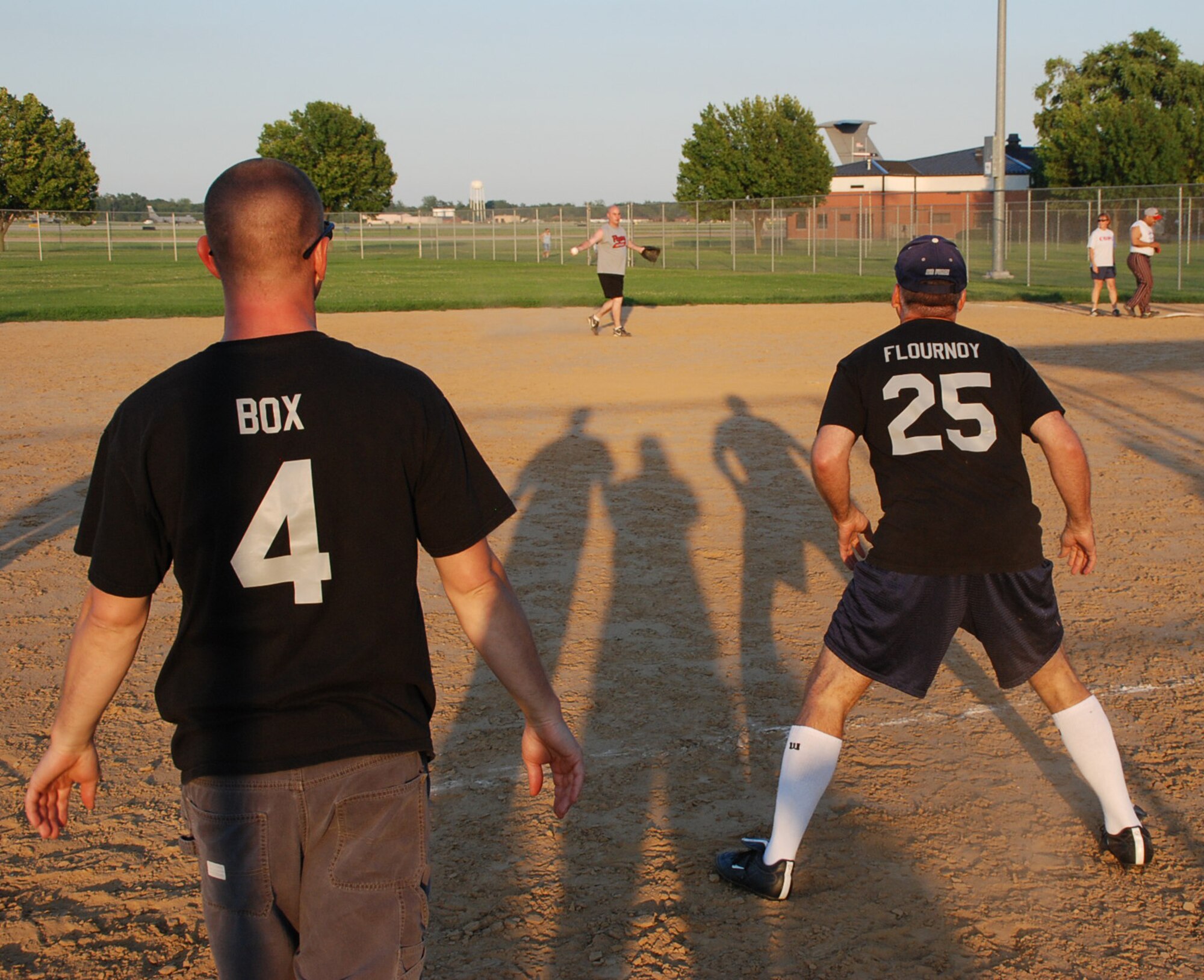 Tech. Sgt. Joseph "Coach" Box cheers on the 932nd Airlift Wing commander, Col. Jay Flournoy, as he leads off of third base during an exciting softball game at Scott Air Force Base, Ill.  Photo/Maj. Stan Paregien