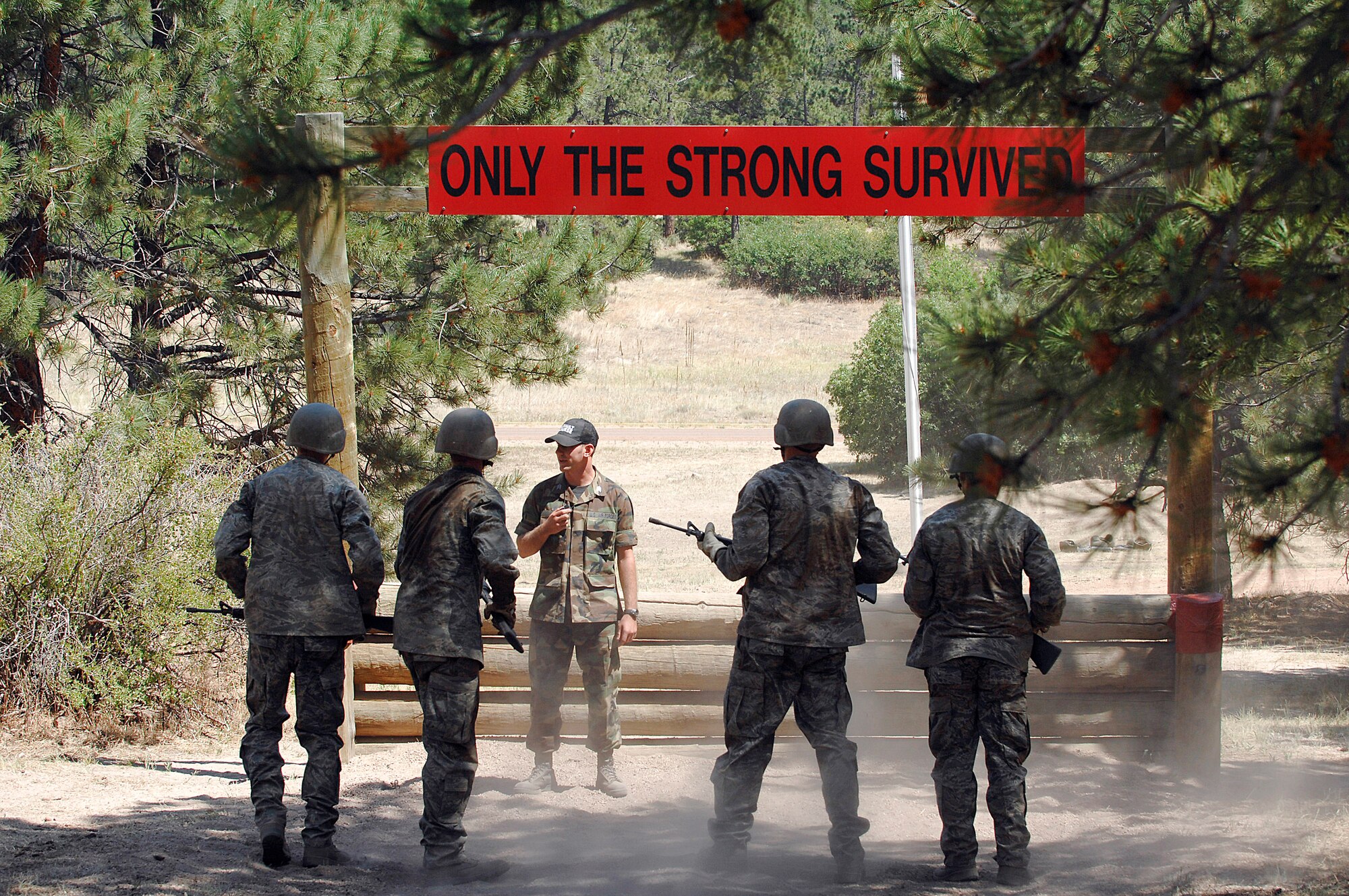 U.S. Air Force Academy basic cadets receive instruction from a cadre member July 16 prior to crossing the final obstacle of the assault course at the Jacks Valley training area near Colorado Springs, Colo., during the field training portion of basic training.  (U.S. Air Force photo/Dave Ahlschwede)