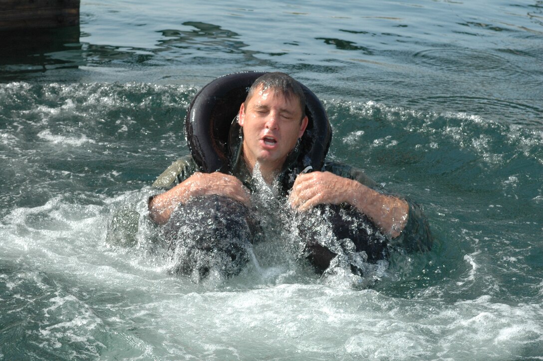 Maj. Steve Haase jumps into the ocean as part of the water survival training. Pilots must complete this training every three years to be able to fly over the ocean. (Air National Guard Photo by 1st Lt. Dan Dodson).