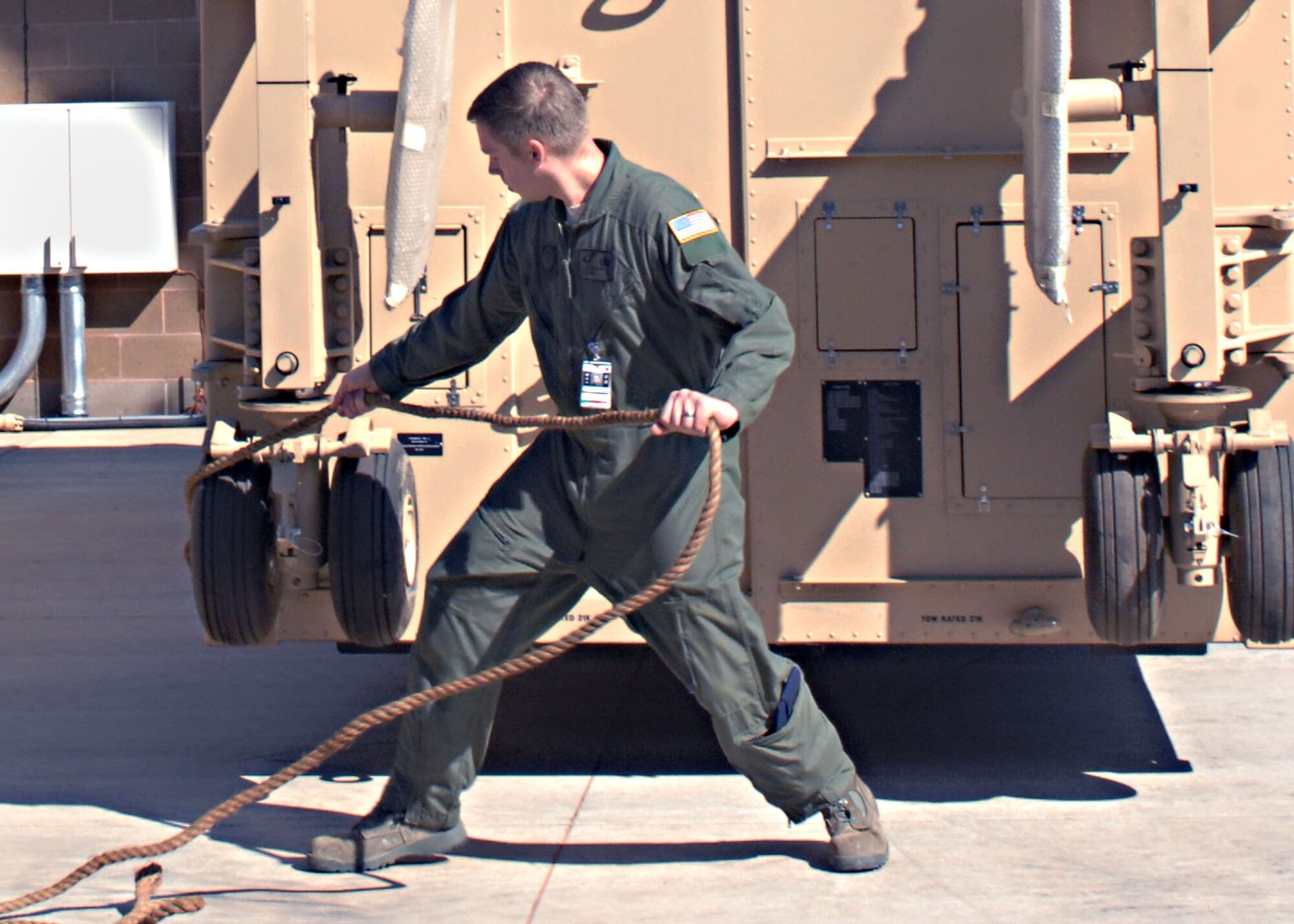 CANNON AIR FORCE BASE N.M.--Tech. Sgt. Justin Michaels moves the Ground Control Station into place at the 3rd Special Operations Squadron patio on July 21.  The GCS will serve as the "cockpit" for the Predator/Reaper, and will control combat orbits from here.  (U.S. Air Force photo by Airman 1st Class James R. Bell)