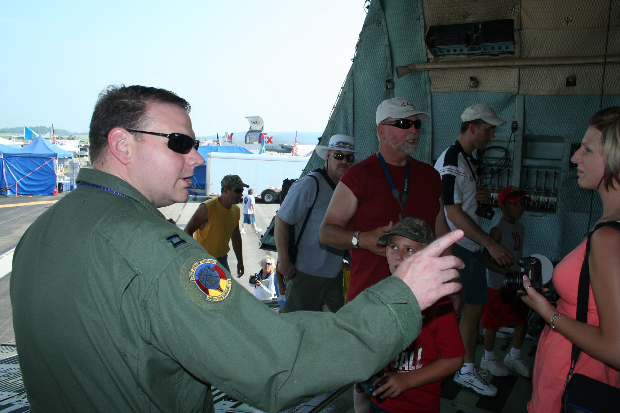 WRIGHT-PATTERSON AFB, Ohio - Capt. Cliff Erli, 89th Airlift Squadron, talks to visitors about the 445th Airlift Wing's C-5 Galaxy.  The 445th Airlift Wing's massive C-5 was the center of attention at the Dayton Airshow. The C-5 is the largest aircraft in the Air Force inventory and is always a crowd pleaser as people can enter at the nose and walk through the aircraft and exit at the tail. In addition to the C-5 static display, the 445th Airlift Wing provided a C-5 flyover on Sunday, July 20, 2008.  (U.S. Air Force photo/Senior Airman Ken LaRock)