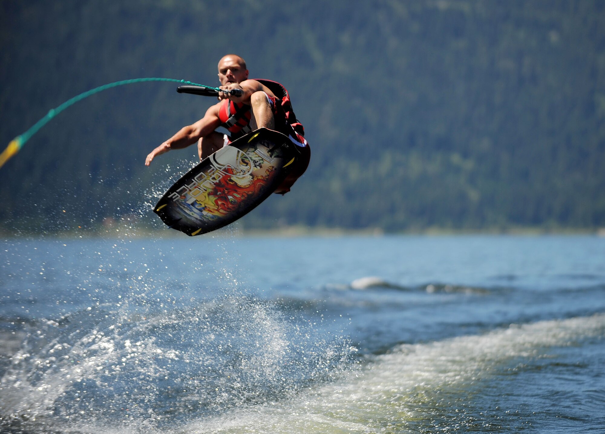 MOUNTAIN HOME AIR FORCE BASE, Idaho -- Senior Airman Kyle Oler, 366th Component Maintenance Squadron, wake boards on Lake Cascade during the Mountain Home Air Force Base marriage retreat July 12. While the chapel hosted the retreat, the entire Integrated Delivery System -- comprised of base agencies committed to helping active duty military members and their families, retirees and department of defense civilians -- provided support. These agencies include, but aren’t limited to, the Airmen and Family Readiness Center, family advocacy, health and wellness center and the chapel.  (U.S. Air Force photo/ Airman 1st Class Ryan Crane)