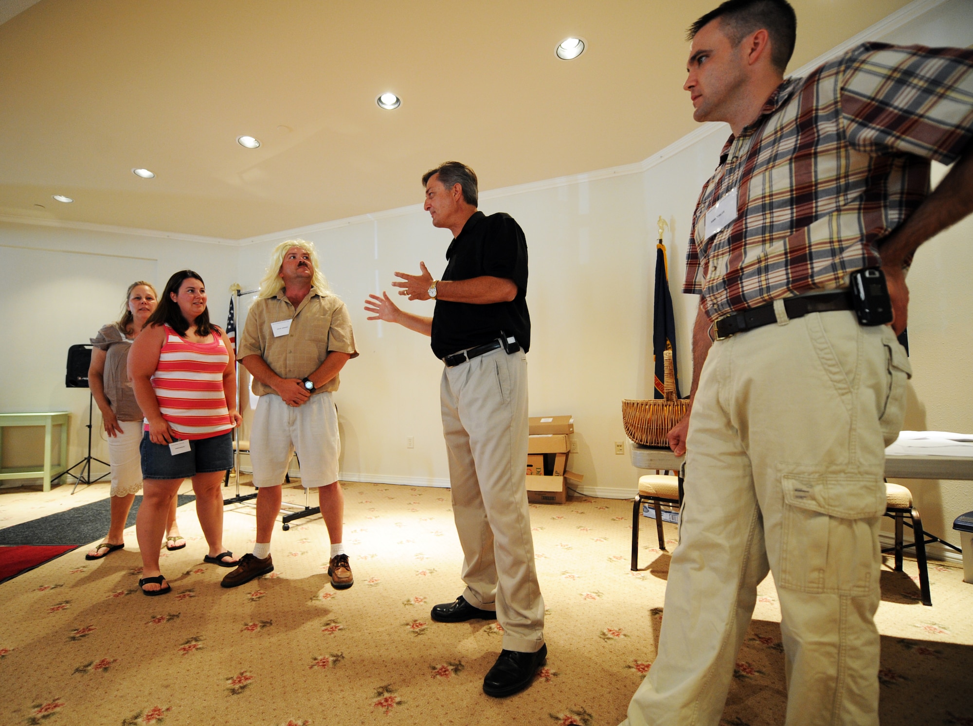 MOUNTAIN HOME AIR FORCE BASE, Idaho -- Center, Master Sgt. Steven Wright and Gary Strickland, class instructors, act out a scenario to teach couples how to communicate better during the Mountain Home Air Force Base marriage retreat July 12. While the chapel hosted the retreat, the entire Integrated Delivery System -- comprised of base agencies committed to helping active duty military members and their families, retirees and department of defense civilians -- provided support. These agencies include, but aren’t limited to, the Airmen and Family Readiness Center, family advocacy, health and wellness center and the chapel. (U.S. Air Force photo/ Airman 1st Class Ryan Crane)