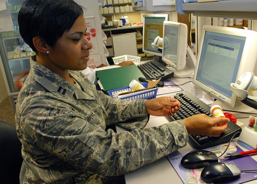BARKSDALE AFB, LA --- Capt. Bridget Moore, a pharmacist assigned to the 2d Medical Support Squadron, performs a check for accuracy on a customer's prescription before it's picked up by the customer at the main pharmacy's temporary location on July 11, 2008.  (USAF Photo by Staff Sgt. Trina R. Jeanjacques)