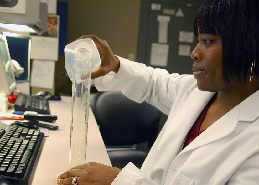 BARKSDALE AFB, LA --- Latasha Taylor mixes antiobotic medications to fill a patient's prescription at the main pharmacy's temporary location on July 11, 2008. Mrs. Taylor is a contractor pharmacist assigned to the 2d Medical Support Squadron. (USAF Photo by Staff Sgt. Trina R. Jeanjacques)