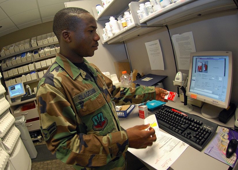 BARKSDALE AFB, LA --- Airman 1st Class Temitope Olageshin, a pharmacy apprentice assigned to the 2d Medical Support Squadron, scans a prescription into "The Pharmacist" computer system at the main pharmacy's temporary location on July 11, 2008. Prescriptions are scanned into "The Pharmacist" system to check for accuracy.  (USAF Photo by Staff Sgt. Trina R. Jeanjacques)