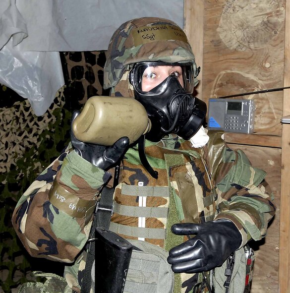 OSAN AIR BASE, Republic of Korea -- Staff Sgt. Klaudyna Polewacz, 51st Aerospace Medical Squadron, takes a moment to rehydrate using the newly-issued M-50 protective mask during a base-wide exercise here July 22. Osan was the first base on the peninsula to issue the new masks. (U.S. Air Force photo/Staff Sgt. Scottie McCord)