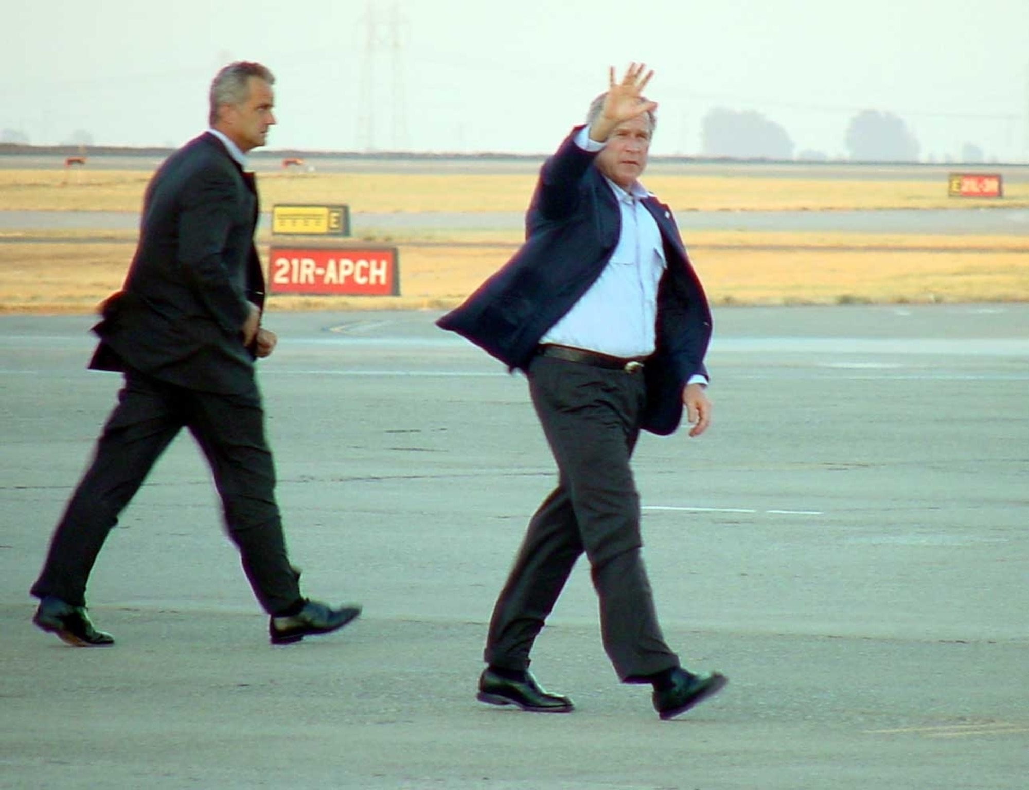 President George Bush waves to Team Travis members on the flightline July 18. The president briefly stopped by Travis before heading to an event in Napa, Calif. (U.S. Air Force photo/Jim Spellman)