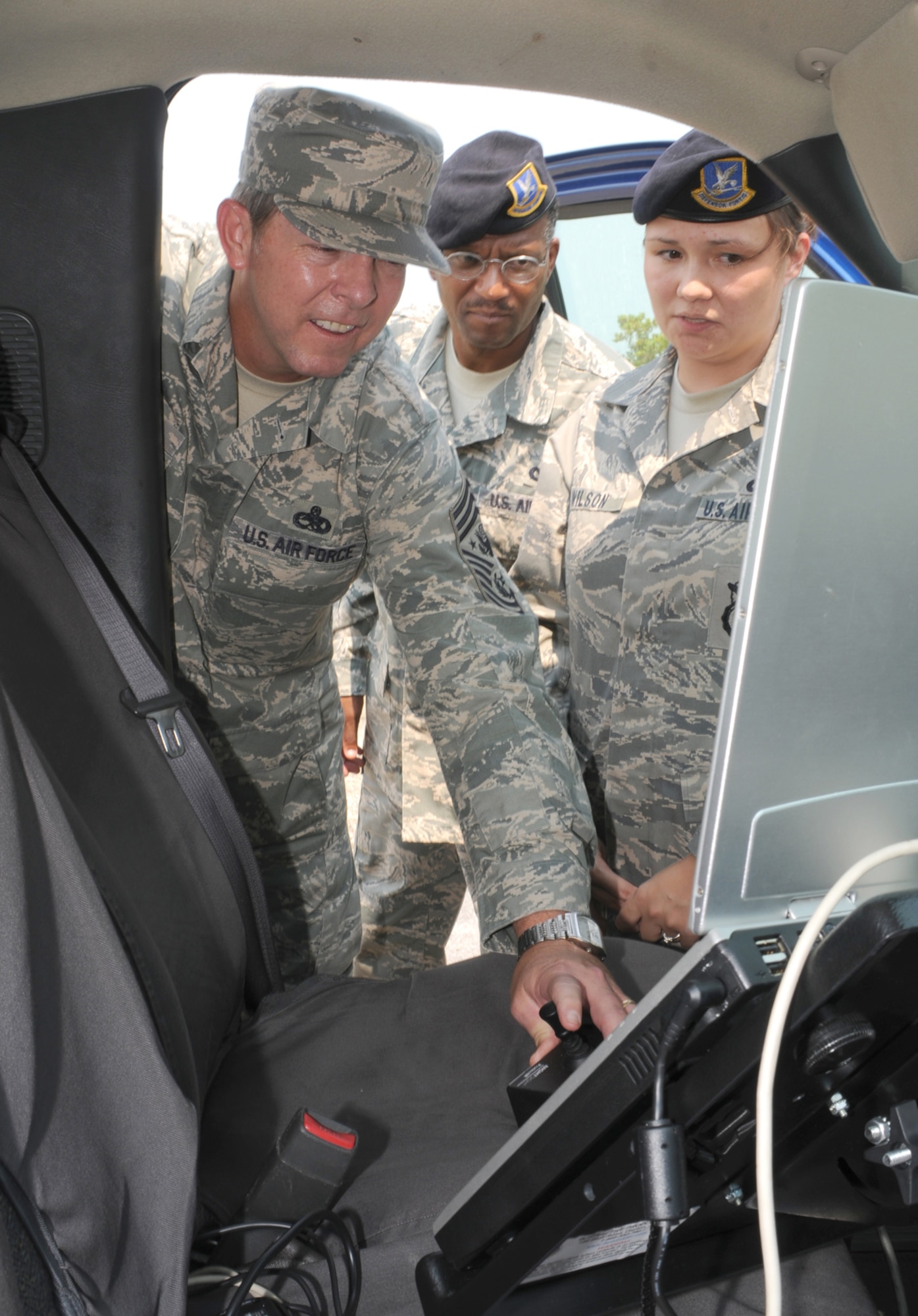 Chief McKinley, left, checks out the perimeter surveillance radar system inside 81st Security Forces Squadron vehicles while being briefed by Chief Master Sgt. Errol Sanders and Staff Sgt. Suge Wilson.  (U.S. Air Force photo by Kemberly Groue)