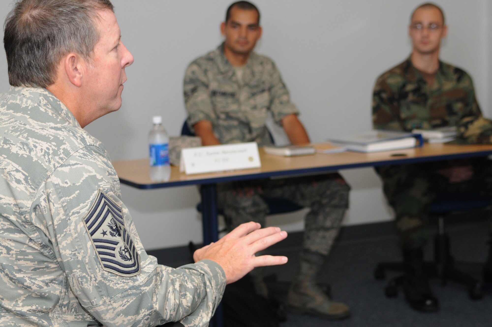Chief McKinley, left, speaks to Airmen 1st Class Aaron Betancourt and Andrew Bouck and other newcomers to Keesler and the Air Force at the First Term Airmen Center.  (U.S. Air Force photo by Kemberly Groue)