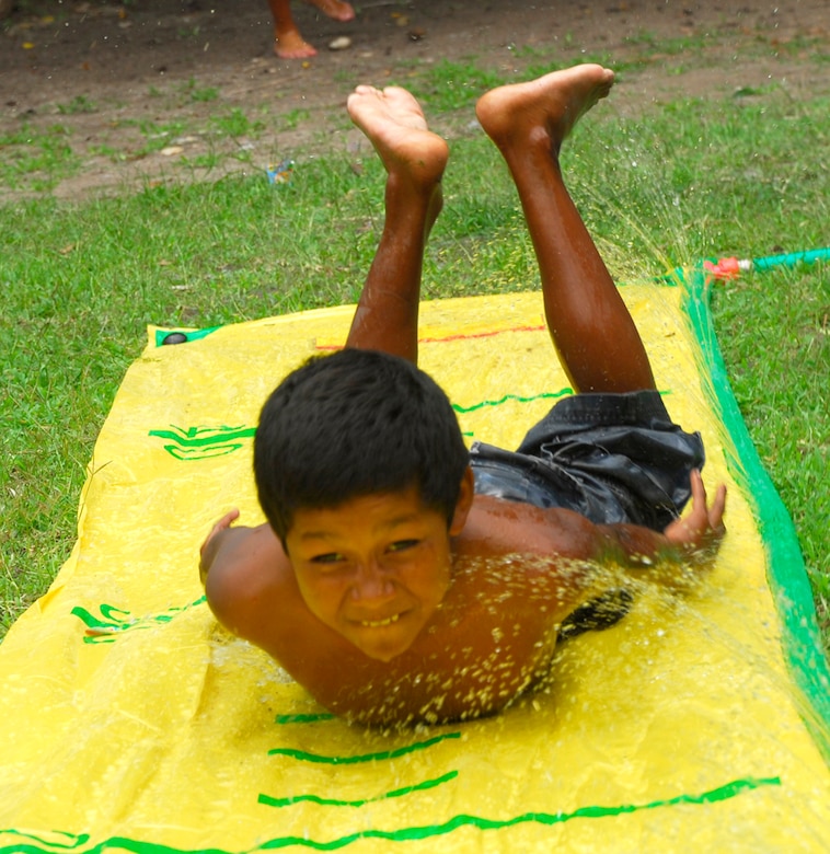 LA PAZ, Honduras ? A child from the San Antonio Orphanage slides down a water game July 19. More than 40 volunteers from JTF-Bravo, 1-228th Aviation Regiment and the Inter Americas Air Force Academy NCO Course came to the orphanage to play games, have a cookout and spend time with children.