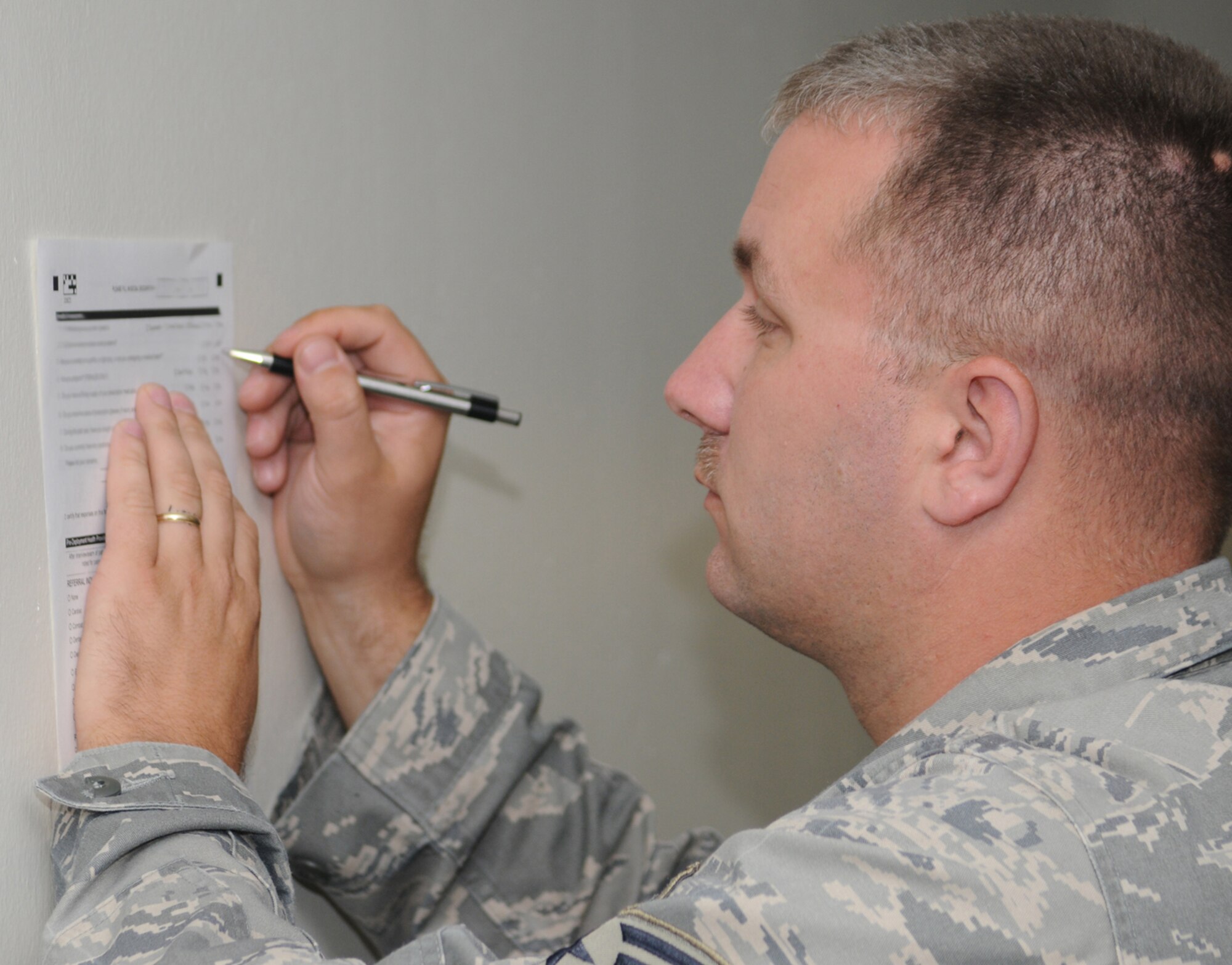 Staff Sgt. Jason Smith, 81st CS, completes a predeployment health assessment form as he processes through the deployment line during the July 15 exercise.  (U.S. Air Force photo by Kemberly Groue)
