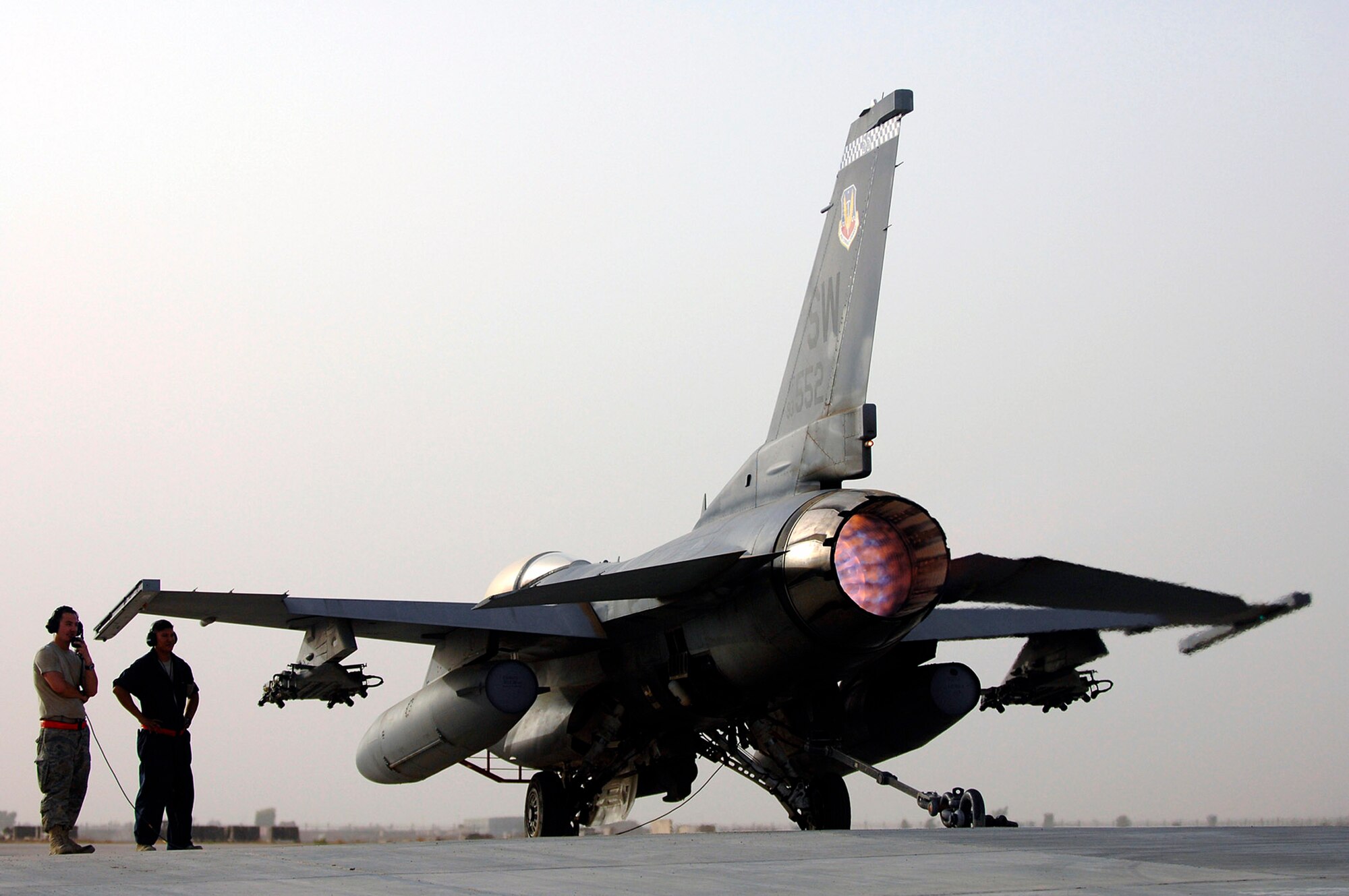 Senior Airman Graham Willis and Staff Sgt. Ferdinand Brown watch as an F-16 Fighting Falcon roars in full afterburner during an engine run up July 16 at Joint Base Balad, Iraq. During a run up, mechanics test all of the engine settings and gauges that pilot use during combat missions. Airman Willis and Sergeant Brown are 77th Aircraft Maintenance Unit engine mechanics deployed from Shaw Air Force Base, S.C. (U.S. Air Force photo/Senior Airman Julianne Showalter) 
