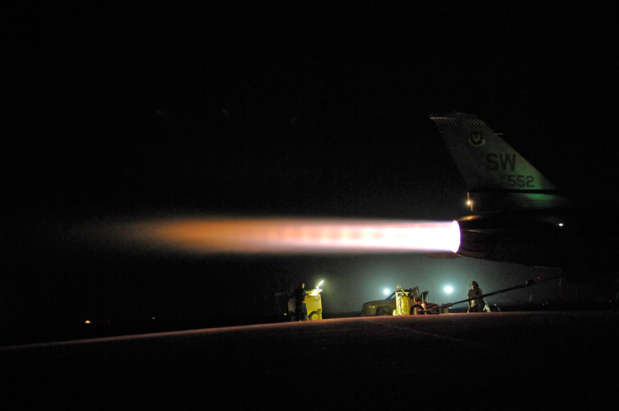 Airmen monitor an F-16 Fighting Falcon as it goes into full afterburner July 16 at Joint Base Balad, Iraq. Senior Airman Graham Willis and Staff Sgt. Michael Danigel communicate back and forth from the cockpit to ground comparing the readings of cockpit computers with the physical responses of the F-16. Airman Willis and Sergeant Danigel are 77th Aircraft Maintenance Unit engine mechanics deployed from Shaw Air Force Base, S.C. (U.S. Air Force photo/Senior Airman Julianne Showalter) 

