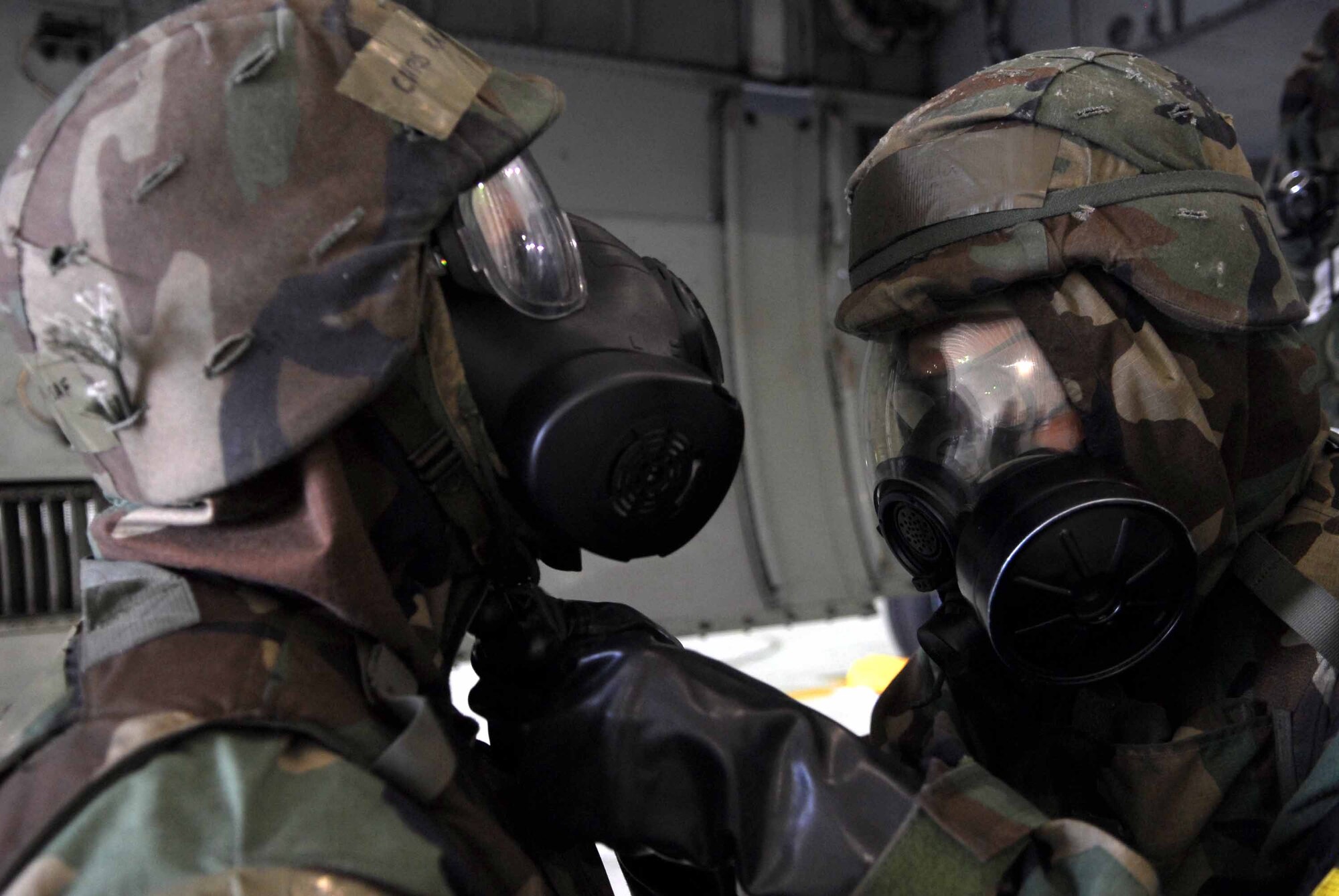 OSAN AIR BASE, Republic of Korea -- Staff Sgt. Shawn Syman, (right), provides a buddy check for Airman Chris Ray after donning MOPP 4 during an exercise here July 22. Both Airmen are aircraft armament systems specialists assigned to the 51st Aircraft Maintenance Squadron. (U.S. Air Force photo/Senior Airman Christopher Boitz)