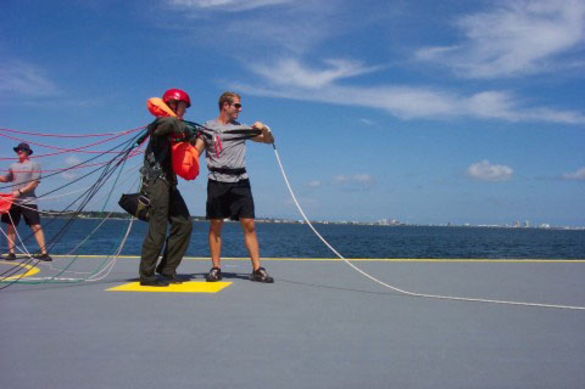 SEYMOUR JOHNSON AIR FORCE BASE, N.C. -- Senior Master Sgt. Dana Bates (middle with red helmet) completes Parachute Water Survival Training at Naval Air Station Pensacola, FL. Sgt. Bates is a Reservist with the 916th Air Refueling Wing and works as the aircrew flight equipment supervisor. In this picture she is preparing to parasail to demonstrate her proficiency in post ejection/bailout procedures. This training will help her train KC-135 and F-15 pilots at Seymour Johnson.
