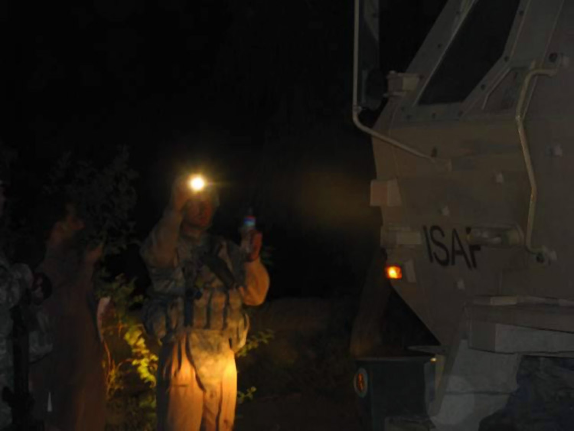 Tech. Sgt. Jason Williams guides in a Mine Resistant Ambush Protected vehicle during a delivery of emergency humanitarian assistance supplies July 3 to residents of the Kuz Kunar and Dari Noor districts of Nangarhar Province, Afghanistan. American servicemembers of the Nangarhar Provincial Reconstruction Team pitched in at the request of the United Nations Assistance Mission in Afghanistan after flash floods struck the area June 30. Sergeant Williams is a Nangarhar Provincial Reconstruction Team mechanic. (Courtesy photo) 
