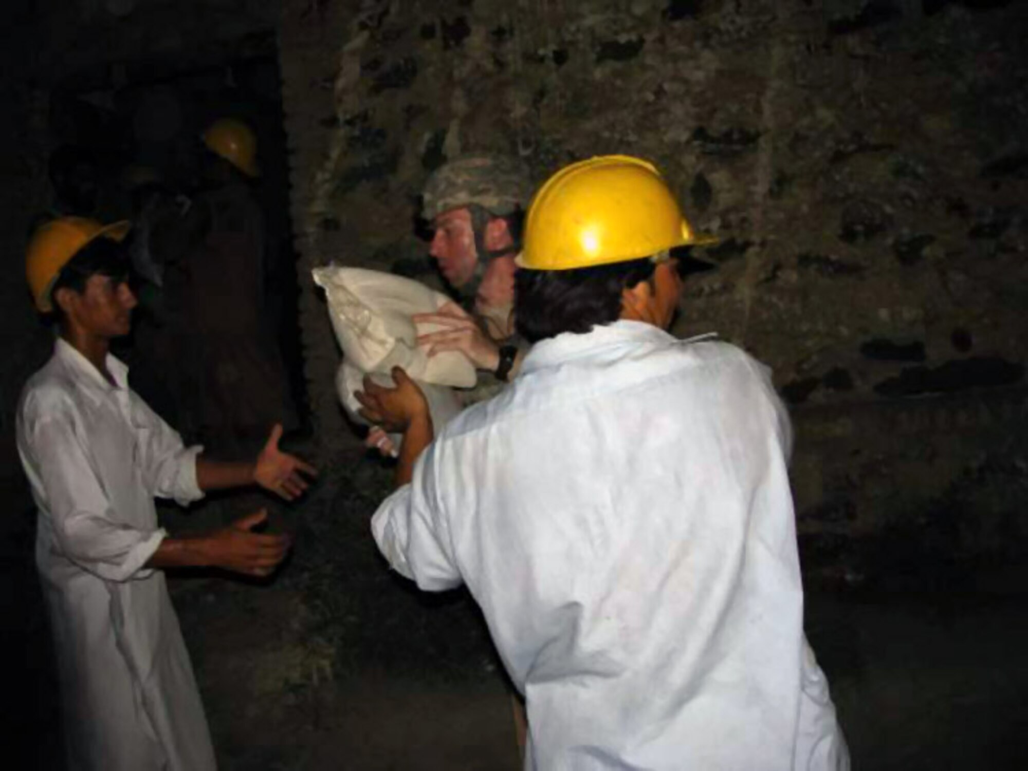 Capt. John Morash delivers emergency humanitarian assistance supplies July 3 to residents of the Kuz Kunar and Dari Noor districts of Nangarhar Province, Afghanistan. American servicemembers of the Nangarhar Provincial Reconstruction Team pitched in at the request of the United Nations Assistance Mission in Afghanistan after flash floods struck the area June 30. Captain Morash is a Nangarhar Provincial Reconstruction Team member. (Courtesy photo) 
