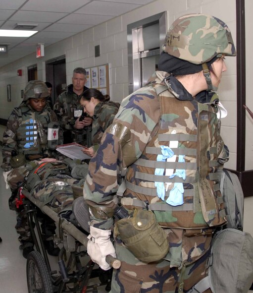 OSAN AIR BASE Republic of Korea -- 51st Medical Group patient administrative technicians and 51st Fighter Wing manpower personnel work together to inprocess a mach patient during a base-wide exercise here July 22. The week-long exercise tests Team Osan’s readiness and ability to execute combat operations, receive follow-on forces and defend the base from attack. (U.S. Air Force photo/Staff Sgt. Lakisha Croley)