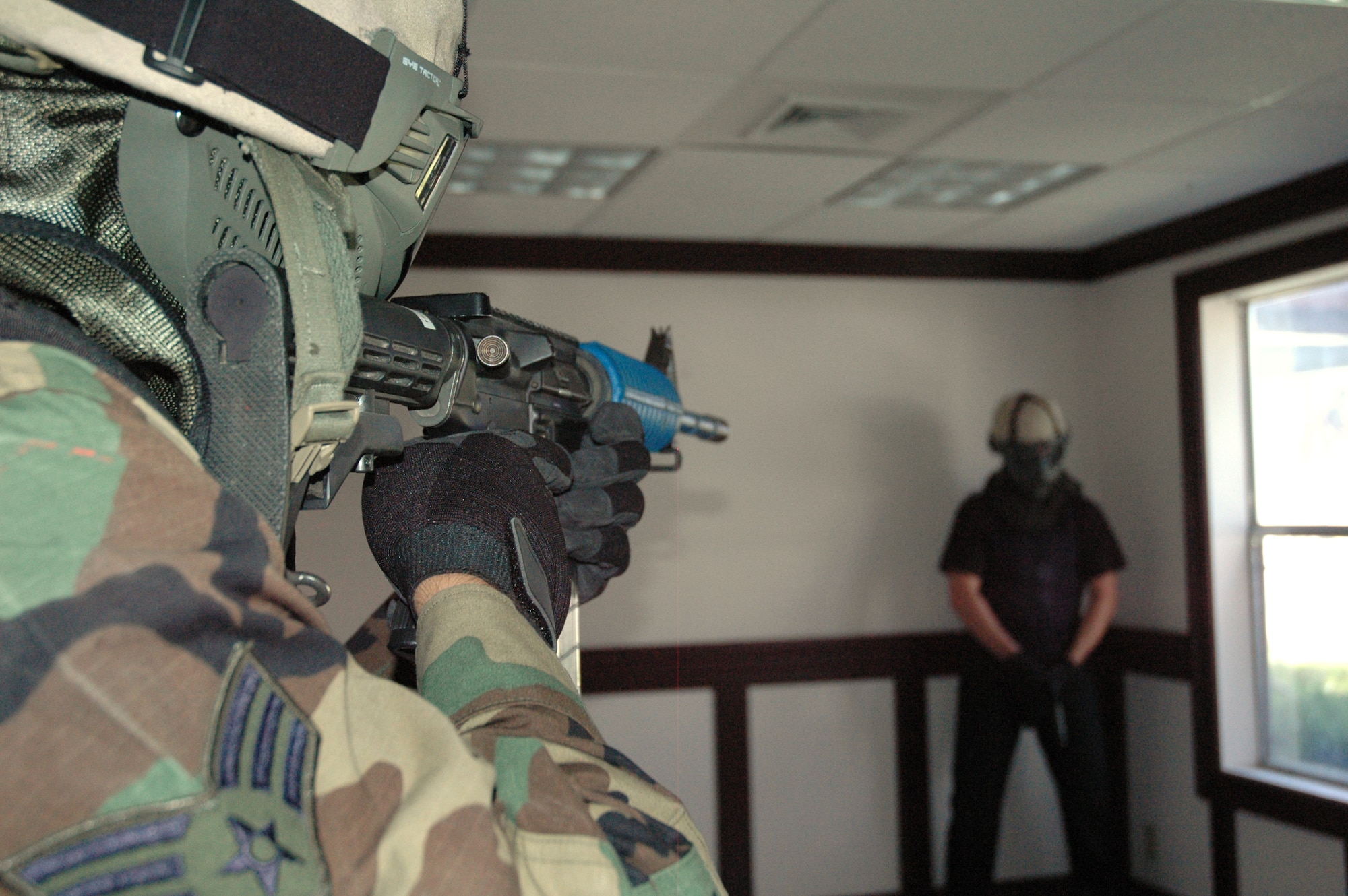 EGLIN AIR FORCE BASE, Fla. -- Senior Airman James Baker, 96th Security Forces Squadron, performs a scenario from the Active Shooter Instructor Training Course held at Bldg. 591. The scenario is one where the hostile threat surrenders and police come in and take him into custody. The training helps military and civilian agencies alike respond to agressive, hostile situations as a joint task force. (U.S. Air Force photo/Staff Sgt. Stacia Zachary)