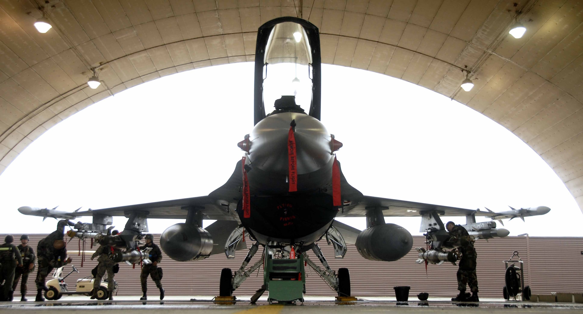 OSAN AIR BASE, Republic of Korea – Team Osan Airmen prepare an F-16 aircraft for an upcoming mission during a base-wide exercise here July 21. The operational readiness exercise tests Team Osan's ability to execute combat operations, receive follow-on forces and defend the base from attack. (U.S. Air Force photo/Senior Airman Christopher Boitz)