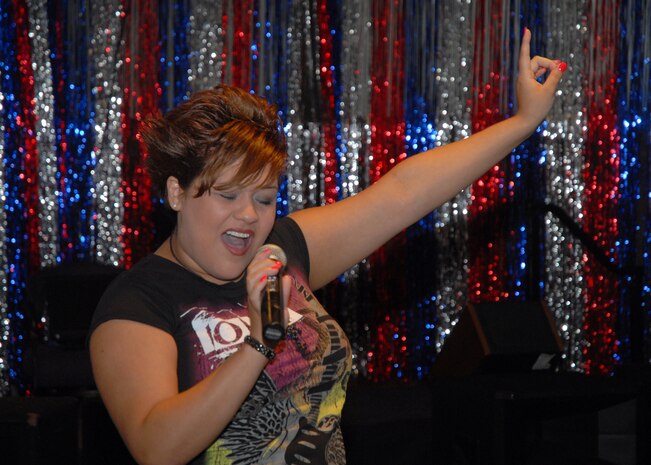 Sabrina Begay performs ?I?m the Only One? at the base-level competition for AMC Icon at the Charleston Club July 18. Mrs. Begay won first place and a cash prize of $500 during the karaoke-style competition loosely based around ?American Idol. Mrs. Begay is the wife of Staff Sgt. Marc Begay. (U.S. Air Force photo/Airman 1st Class Melissa White)