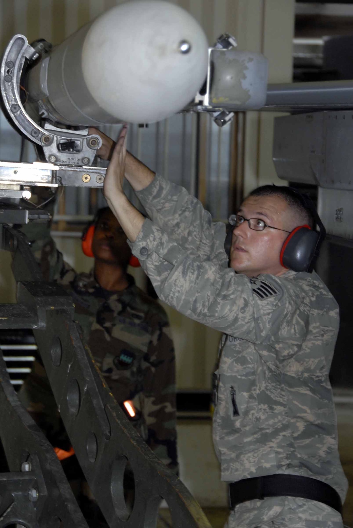 OSAN AIR BASE, Republic of Korea -- Staff Sgt. Andrew Stover, 51st Aircraft Maintenance Squadron weapons loader, guides a jammer carrying an AIM-120 to an F-16 Fighting Falcon to be up loaded during the base-wide exercise here July 21. The operational readiness exercise tests Team Osan's ability to execute combat operations, receive follow-on forces and defend the base from attack. (U.S. Air Force photo/Staff Sgt. Lakisha Croley)