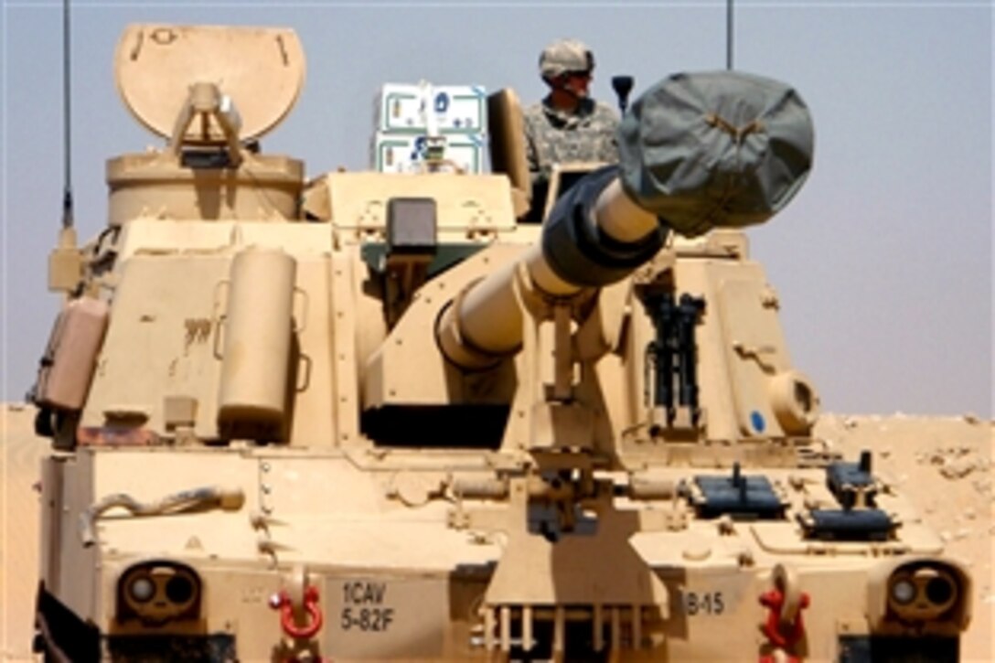 A U.S. soldier and Paladin crew member waits in his mobile howitzer to head to an artillery range in Kuwait, July 19, 2008 The soldier is assigned to the 1st Cavalry Division's 5th Battalion, 82nd Field Artillery Regiment.

