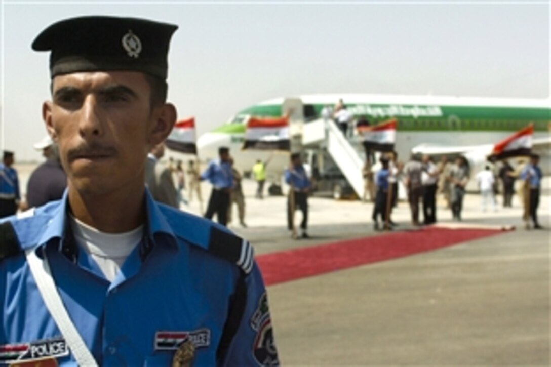 An Iraqi police officer stands guard during a ceremony attended by U.S. officials and Iraqi  leaders to mark the opening of the Najaf International Airport, Iraq, July, 20, 2008.