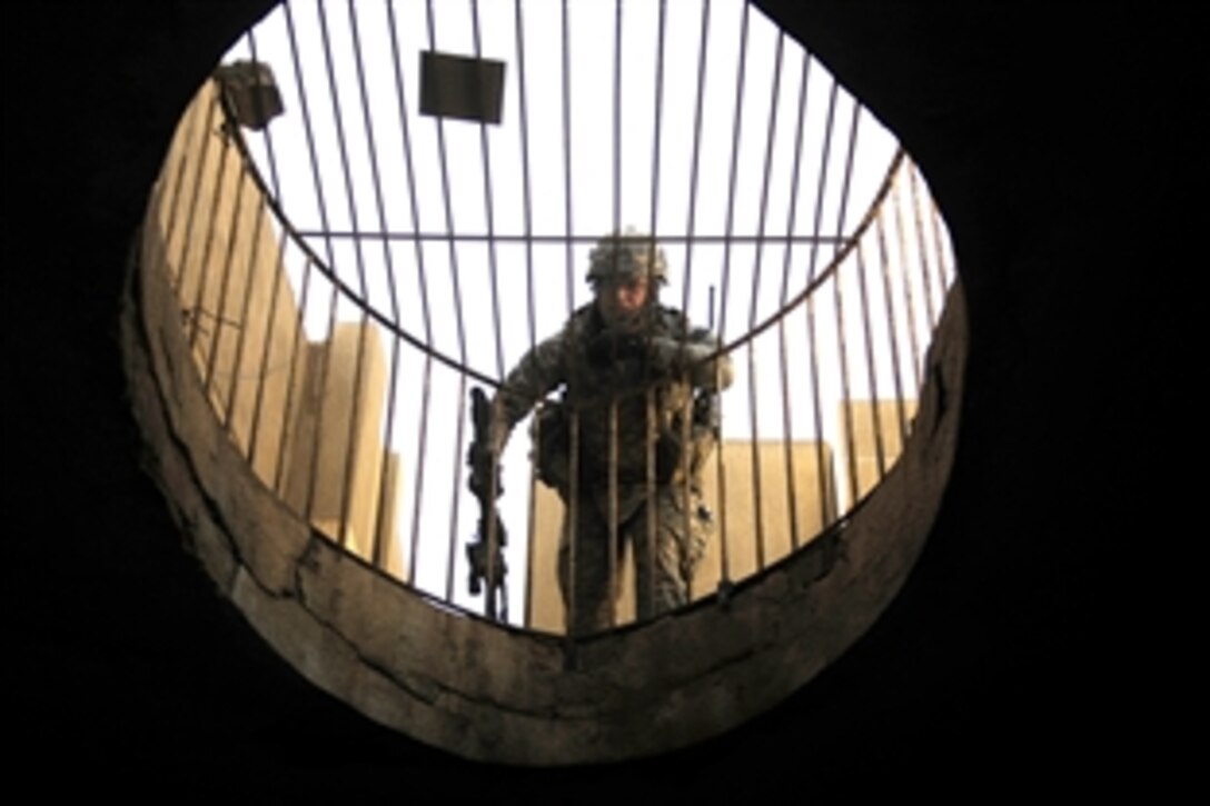 U.S. Army Staff Sgt. Travis Coley speaks to another soldier on a lower level during a search of a Red Crescent aid station in Northern Adl, Iraq, July 14, 2008. The soldiers are assigned to the 4th Infantry Division's Company B, 1st Battalion, 22nd Infantry Regiment.