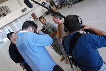 Television host Ian Wright talks with Chief Master Sergeant Rita Green and Senior Airman Thomas Liscomb, 18th Equipment Maintenance Squadron, about maintentance operations. Mr Wright visited Kadena Air Base July 21-22 for his new series called "Ian Wright: Out of Bounds". While at Kadena, he toured various 18th Wing units, interacted with Airmen and took part in some "hands-on" activities designed to highlight the diverse roles and missions of the largest U.S. air base in the Pacific. The episode will air on the Travel Channel and Discovery Channel Asia in October 2008. (U.S. Air Force photo/Staff Sgt. Christopher Hummel)