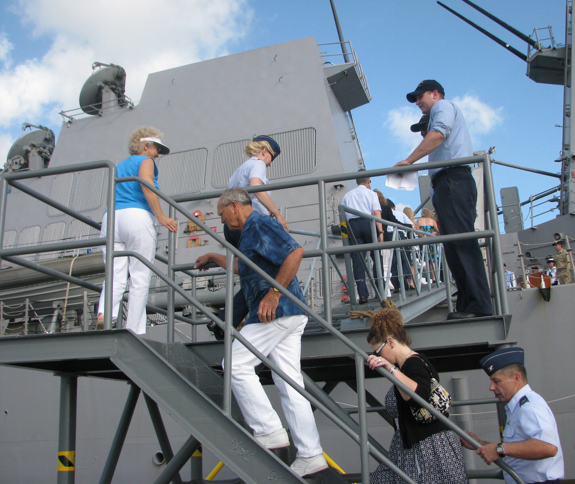 15th Airlift Wing leaders and their family members getting on board to USS Chafee for a tour and mission brief before a pass and review of the ‘Great White Fleet’ at  Pearl Harbor July 18. (U.S. Air Force photo/Jackie Hites)