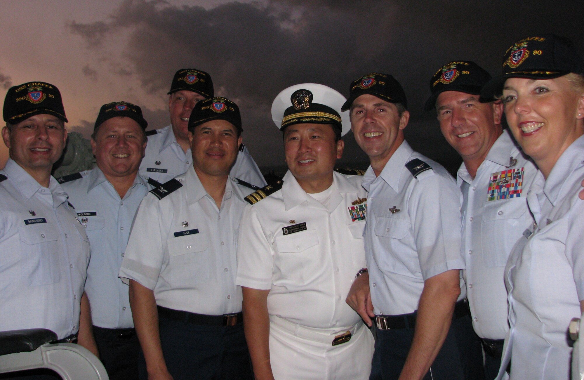 In honor of the 100th anniversary of the Great White Fleet, U.S. Navy Cmdr. Heedong Choi, commander of the USS Chafee (DDG 90) and his crew welcomed the 15th  Airlift Wing leaders and their family members on a tour of the ship during a pass and review at Pearl Harbor July 18. From left, Col. Charles Baumgardner, Col. Dean Wolford, Col. John Lipinski, Col. Giovanni Tuck, Cdr. Choi,  Col. Richard McClain, Chief Master Sgt. Thomas Westermeyer and Col. Debra Doty. Cmdr Choi and his executive officer, Lt. Cmdr. Matthew, Roberts gave a brief history about the ship and its mission. (U.S. Air Force photo/Jackie Hites)