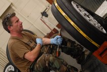 Television host Ian Wright prepares to help torque a bolt on an F-15 main wheel July 20. He visited Kadena Air Base July 21-22 for his new series called "Ian Wright: Out of Bounds". While at Kadena, Mr. Wright toured various 18th Wing units, interacted with Airmen and took part in some "hands-on" activities designed to highlight the diverse roles and missions of the largest U.S. air base in the Pacific. The episode will air on the Travel Channel and Discovery Channel Asia in October 2008. (U.S. Air Force photo/Staff Sgt. Christopher Hummel)