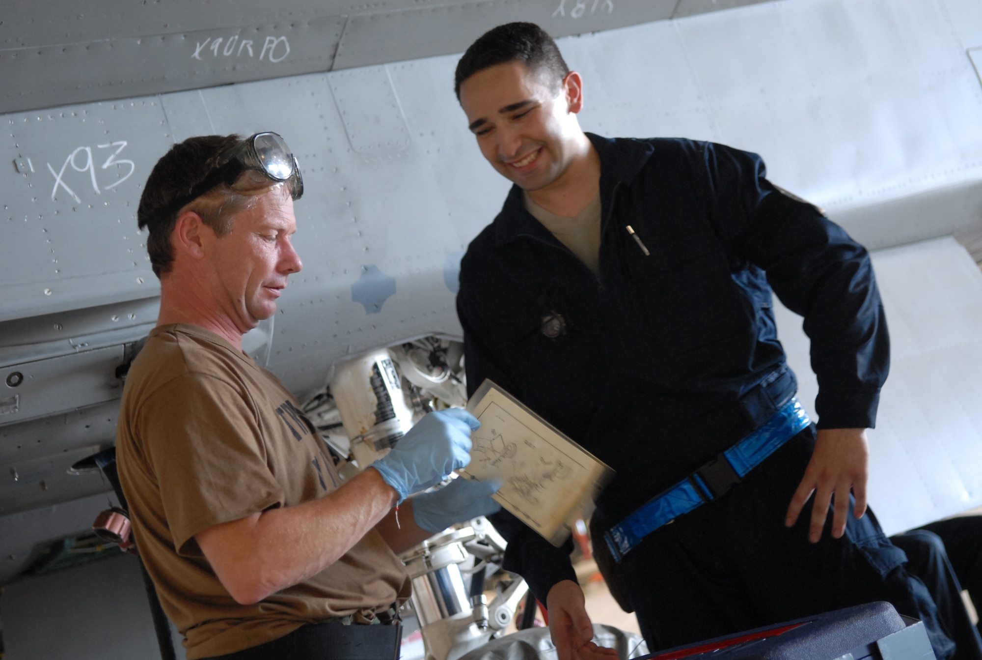 Television host Ian Wright talks with Senior Airman Thomas Liscomb, an inspection section team member assigned to the 18th Equipment Maintenance Squadron, as they prepare to lubricate components of an F-15. Mr Wright visited Kadena Air Base July 21-22 for his new series called "Ian Wright: Out of Bounds". While at Kadena, he toured various 18th Wing units, interacted with Airmen and took part in some "hands-on" activities designed to highlight the diverse roles and missions of the largest U.S. air base in the Pacific. The episode will air on the Travel Channel and Discovery Channel Asia in October 2008. (U.S. Air Force photo/Staff Sgt. Christopher Hummel)