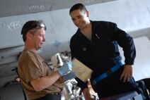 Television host Ian Wright talks with Senior Airman Thomas Liscomb, an inspection section team member assigned to the 18th Equipment Maintenance Squadron, as they prepare to lubricate components of an F-15. Mr Wright visited Kadena Air Base July 21-22 for his new series called "Ian Wright: Out of Bounds". While at Kadena, he toured various 18th Wing units, interacted with Airmen and took part in some "hands-on" activities designed to highlight the diverse roles and missions of the largest U.S. air base in the Pacific. The episode will air on the Travel Channel and Discovery Channel Asia in October 2008. (U.S. Air Force photo/Staff Sgt. Christopher Hummel)